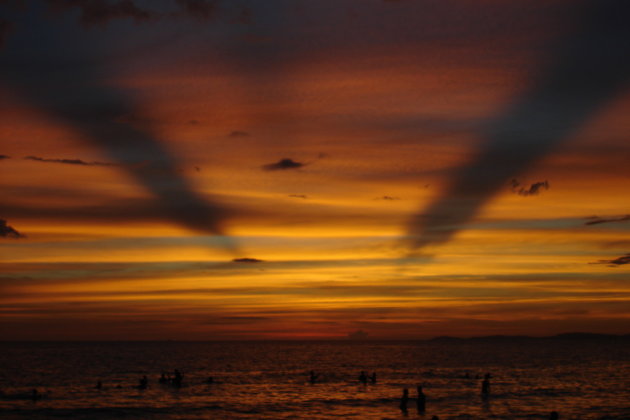 Locals in the sea during sunset