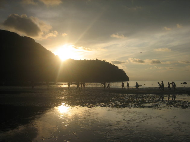 Voetballende thaise kinderen op het strand van koh phi phi