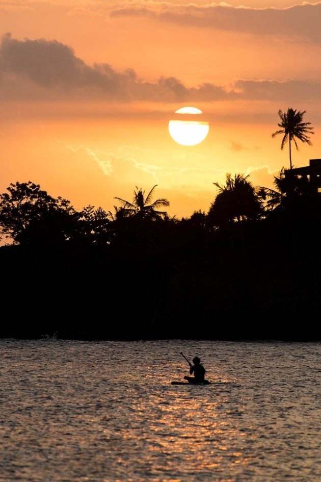Eenzame peddelaar tijdens zonsondergang op Lombok