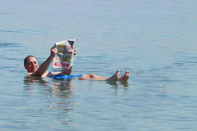 drijven op de dode zee met de krant